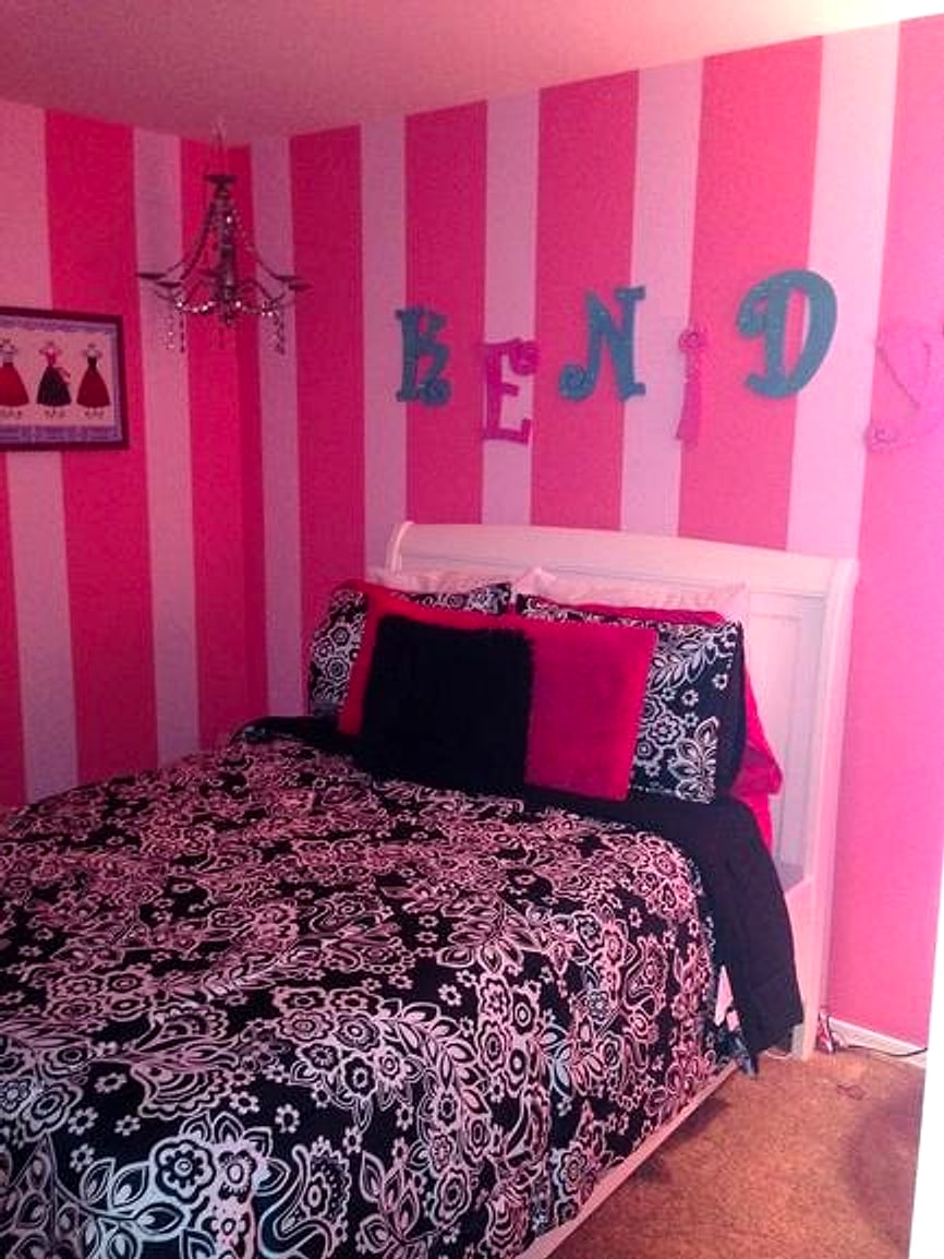 Girl’s bedroom painted in pink vertical stripes